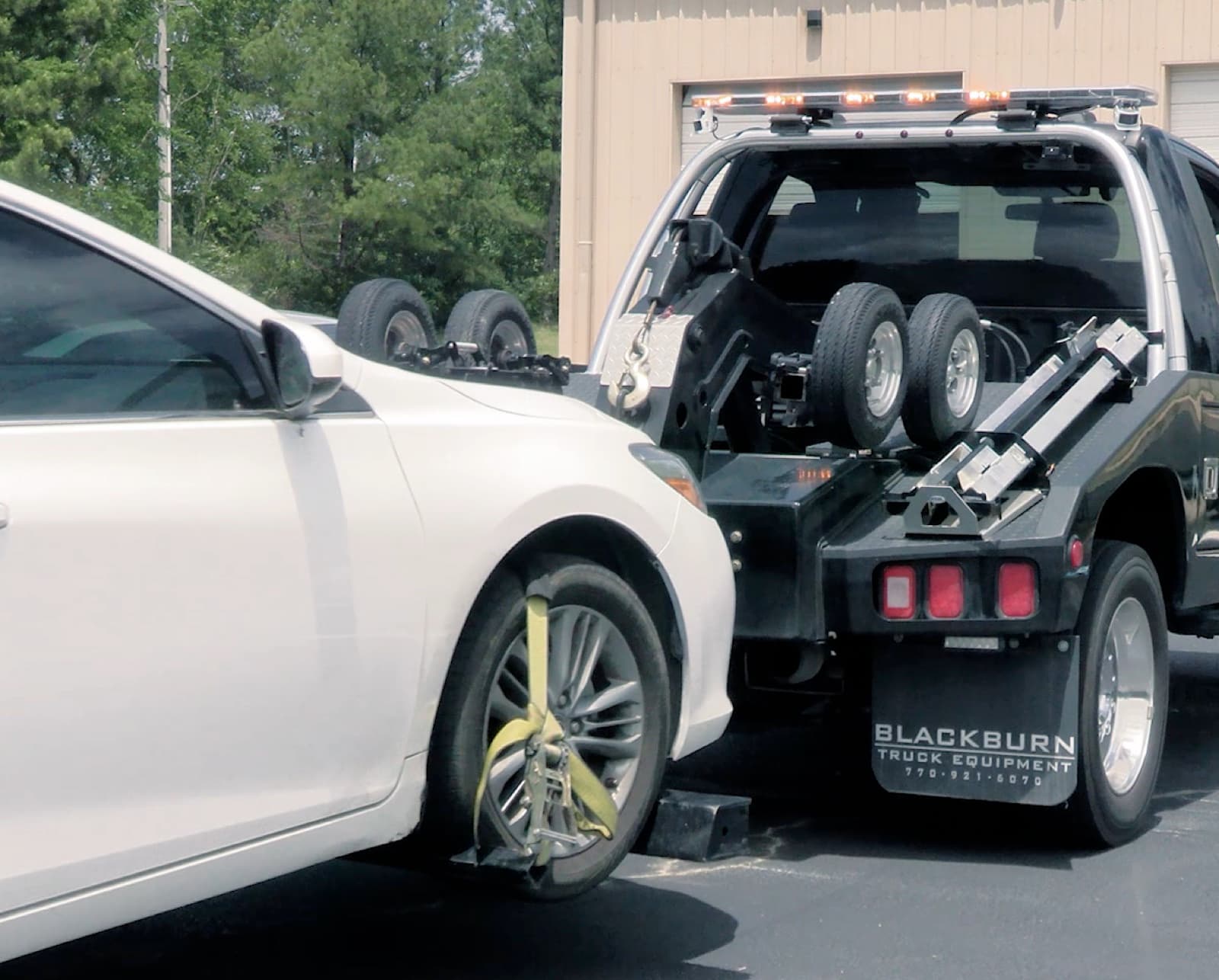 A wheel-lift securing a vehicle during a repossession